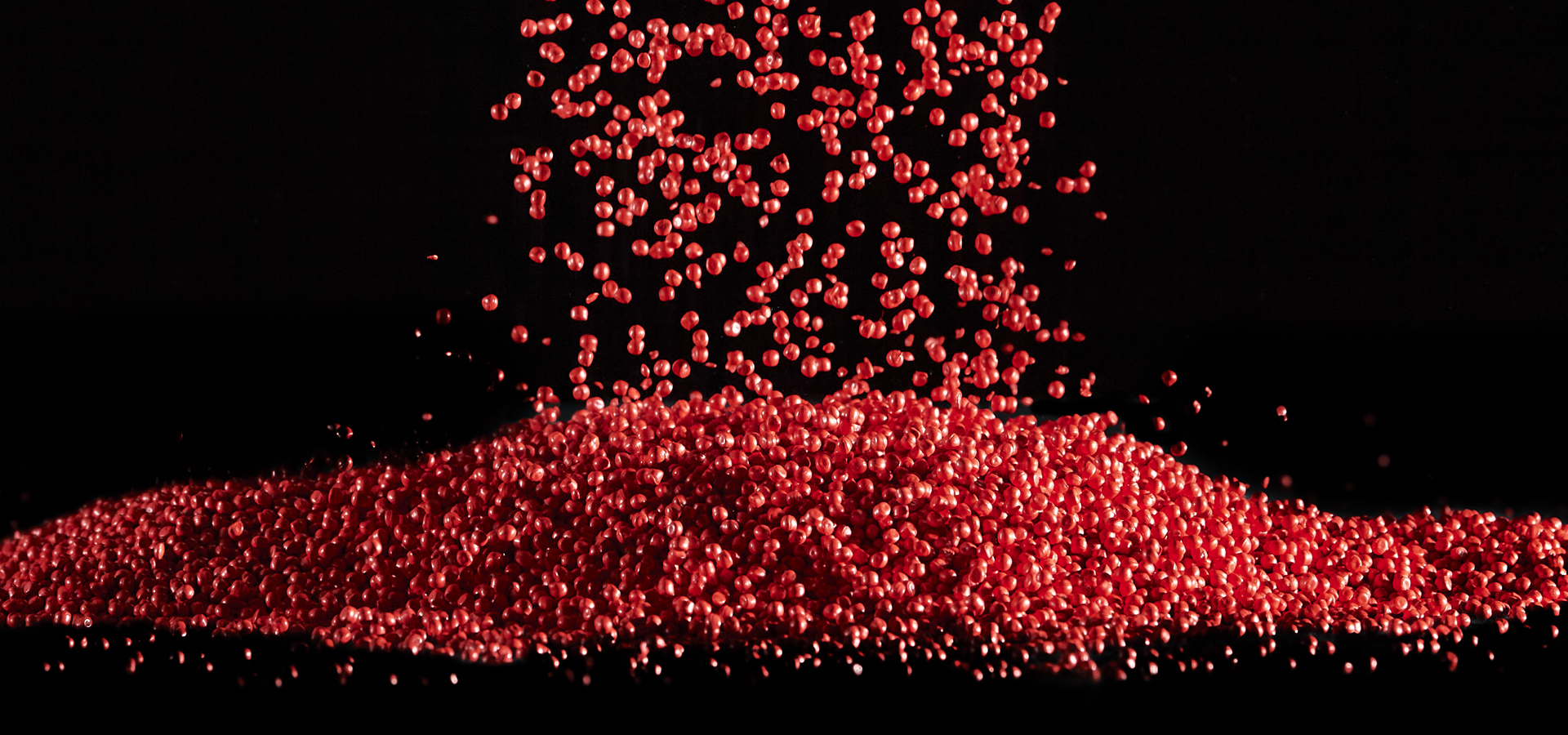 Red flowing plastic granules
