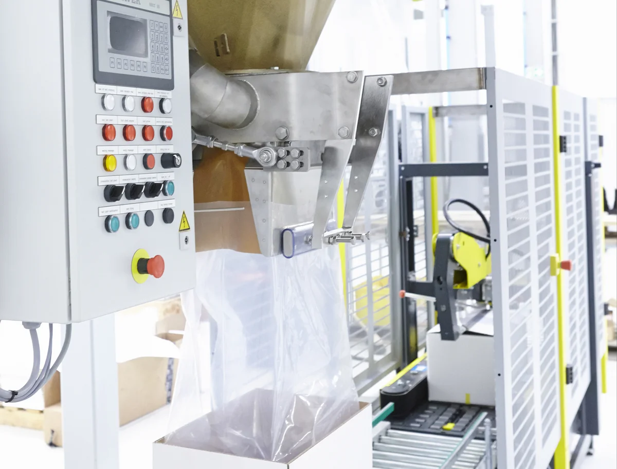 Net weigher for open bag filling