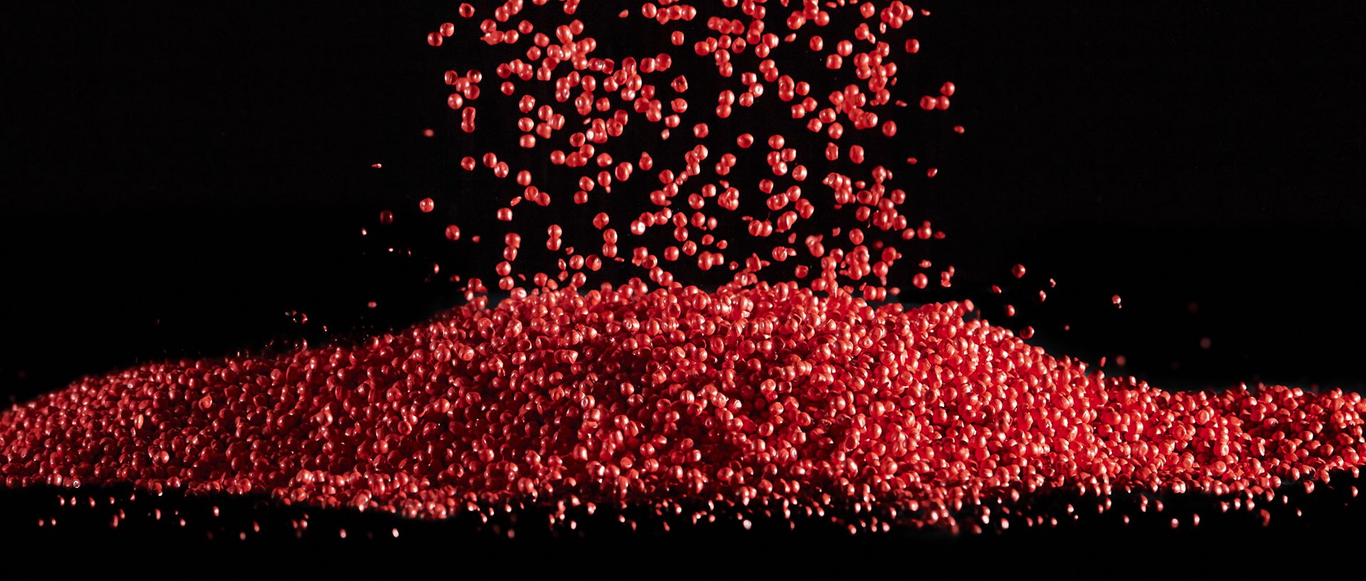 Red flowing plastic granules