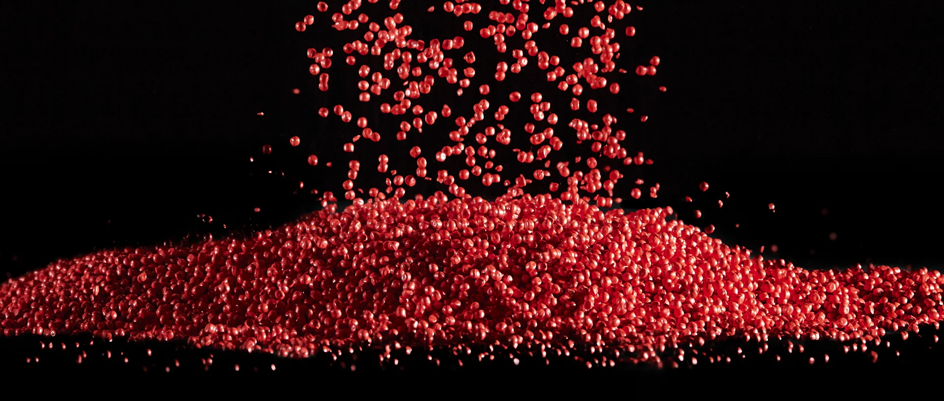 Red flowing plastic granules